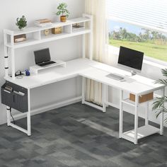 a white computer desk sitting in front of a window next to a potted plant