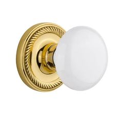 an image of a door knob with a white ball on the front and gold trim