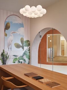 a wooden table sitting in front of a mirror