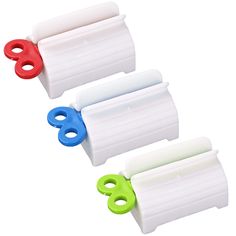 three rolls of toilet paper with colored handles