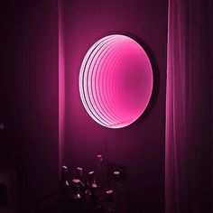 there is a purple light in the room and it looks like an orb on the wall