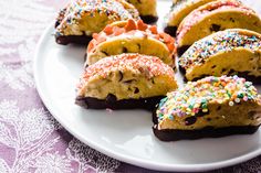 a white plate topped with cookies and sprinkles on top of a table