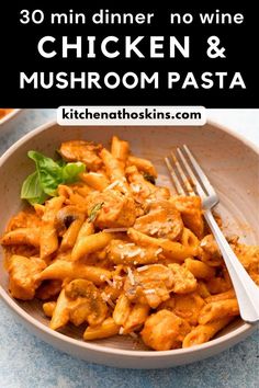 chicken and mushroom pasta in a white bowl with a fork on the side next to it