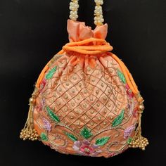 floral texture zardosi thread embroider peach silk hand bag for woman designer | wedding favor drawstring purse pouch with beaded chainPackage Contents: 1Size: 10" x 8"Designed with the heart, this beautiful Potli or batawa bag are eye catchy and made of premium material.Key Features:Zardosi embroidery art work. This potli is good match with both Indian and western outfits and are superb for wedding and festive parties.This would be best complement to your designer saree, lenhga or any other kin Festive Floral Embroidery Potli Bag, Festive Floral Embroidered Potli Bag, Traditional Orange Pouch Bag, Pink Handwork Potli Bag For Diwali, Pink Zari Work Potli Bag For Festivals, Pink Potli Bag With Dori Work For Gifts, Floral Embroidery Potli Bag For Festivals, Festival Gift Potli Bag With Floral Embroidery, Festival Floral Embroidery Pouch Potli Bag