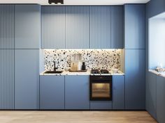 a kitchen with blue cabinets and white counter tops is seen in this image from the front view