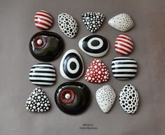 a collection of painted rocks sitting on top of a table