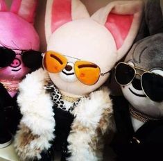 several stuffed animals wearing sunglasses and jackets