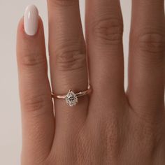 a woman's hand with a diamond ring on it