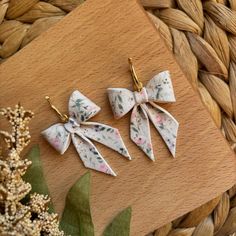 three small bows are hanging on a wooden board