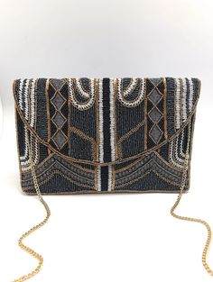 Size: 10 1/2 inches by 8 1/2 inches Color: Black, Gold, Silver Hand Beaded and Sequin This Bag is a Showstopper! Chain Included and can be worn as a cross-body. Please note: Earrings are sold separately Black Beaded Rectangular Clutch, Black Beaded Bohemian Bags, Bohemian Black Beaded Shoulder Bag, Bohemian Black Shoulder Bag For Evening, Black Beaded Clutch, Beaded Clutch Bag, Beaded Clutch, Handbag Wallet, Beaded Bags