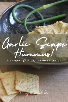 garlic and hummus in a bowl with crackers