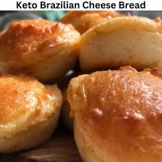 some kind of bread sitting on top of a wooden cutting board with the words keto brazilian cheese bread