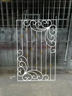 an iron gate in front of a metal fence