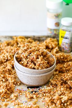 a bowl filled with granola sitting on top of a table next to confetti