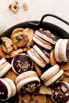 a pan filled with cookies and chocolate covered macaroons