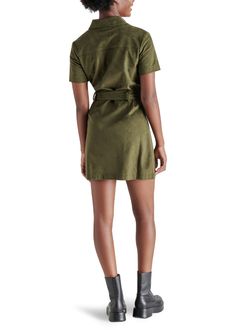 Experience the feel of luxurious faux suede in the Steve Madden Jolene Dress. This olive green mini dress features a tie at the waist, providing a sleek silhouette perfect for any occasion—from a girls night out to holiday festivities. Elevate your look with knee-high boots for a stylish fall look. Fit: True to Size Model is wearing a size S Imitation Leather: 100% Polyurethane Button closure all the way down If you would like to see more photos or speak with one of our stylists with any further Suede Dress Outfit, Green Suede Dress, Faux Suede Fabric, Leather Mini Dress, Loungewear Jumpsuit, Green Mini Dress, Suede Dress, Green Suede, Midi Maxi Dress