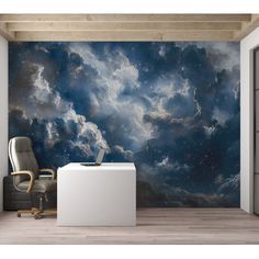 an office with a desk and chair in front of a wall mural that has clouds on it