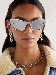 Matthew M. Williams makes his mark at Givenchy with styles like these sleek, futuristic sunglasses. 3D printed in Italy, they have angular cat-eye frames with sharp temples that almost create a wrap-around effect. Though free from obvious branding, the silver-tone metal that curves around the lenses subtly resembles a 'G'. Futuristic Silver Sunglasses With Mirrored Lenses, Modern Cat Eye Shield Sunglasses With Uv Protection, Futuristic Cat Eye Shield Sunglasses With Tinted Lenses, Modern Shield Sunglasses With Mirrored Lenses, Modern Cat Eye Shield Sunglasses, Futuristic Cat Eye Sunglasses With Tinted Lenses, Futuristic Cat Eye Sunglasses With Mirrored Lenses, Evening Cat Eye Shield Sunglasses With Mirrored Lenses, Futuristic Cat Eye Sunglasses With Uv Protection