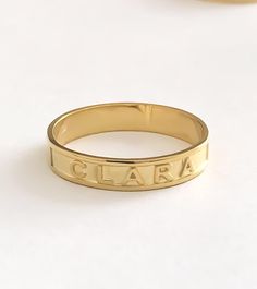 PERSONALIZED NAME and WORD RING This minimalist and Dainty custom Name Ring, Minimalist Name Ring can be worn every day. Personalize this ring with your name, Roman numerals, coordinates and words. Simple and elegant design makes a perfect gift for all special occasions! FEATURES Material: Crafted in 18K Gold plated .925 Sterling Silver and 14K solid Gold Color: Silver, Gold, Rose Gold The item will come with a gift box. The premium hand formed ring is 4mm wide and 1mm thick All our jewelry is % Roman Numeral Ring, Mantra Ring, Word Ring, Rings Personalized, Dainty Initial Necklace, Stack Rings, Name Ring, Personalized Ring, Name Rings