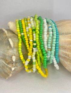 Buy 10, Get 2 Free. Add vibrant colors to your wrist with our stunning 12 pack of Bohemian Beaded Beach Bracelets. These bracelets feature a dazzling combination of colorful yellow, green, aqua, and white rice beads. Half are solid colors and half are a mix of colors for a great variety you can mix or match to add a pop of color to any outfit. These are the perfect beach, vacation or summer accessory.  Each set includes 12 bracelets, allowing you to mix and match according to your mood and style Etsy Bracelets, Antique Silver Earrings, Beading Cord, Yellow Lime, Beach Bracelets, Green Aqua, Rice Bead, Beads Jewellery, Buy Bead