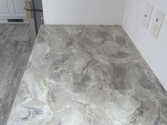 a marble counter top in a kitchen with white cabinets