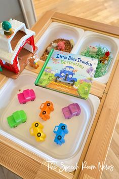 there is a tray with toys on it and a children's book in the background