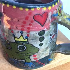 a ceramic mug with an image of a frog on it