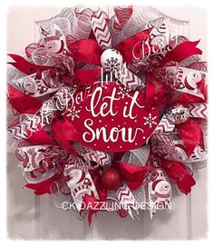 a red and white wreath that says let it snow