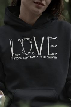 a woman wearing a black hoodie with the word love printed on it