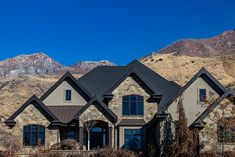 a large house with mountains in the background