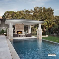 a pool with a fire place next to it