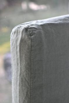 the back end of a couch in front of a window