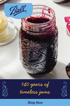 a jar filled with jam sitting on top of a table