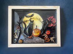 a halloween scene is displayed in a shadow box