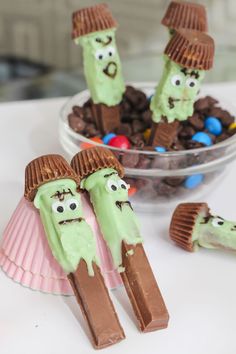 chocolate covered desserts in the shape of characters with green frosting and candy candies