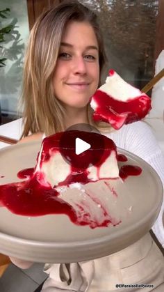 a woman holding a plate with some food on it