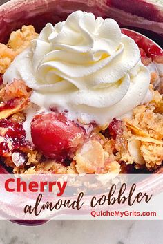 a close up of a bowl of food with whipped cream on top