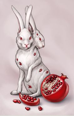 two white rabbits sitting next to a pomegranate