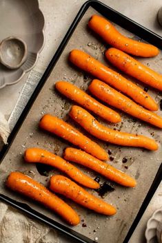 raw carrots on a baking sheet ready to be cooked in the oven for roasting