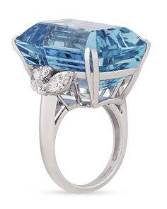 With the stunning blue hue of a clear tropical ocean, the incredible 43.37-carat emerald-cut aquamarine at the center of this ring is absolutely captivating. This specimen possesses the deeply saturated Santa Maria blue hue that is found only in the rarest variety of these stones. Named in honor of Santa Maria de Itabira, the mine in Brazil where they were first discovered, aquamarines that possess this "deep sea" color are highly sought after. This gem is joined by 1.21 carats of marquise- and round-cut white diamonds in its platinum setting. With a name derived from the Latin for "seawater," it's no surprise that the calming color of aquamarine is often compared to a clear blue ocean. Ancient peoples believed anyone who wore the jewel, especially mariners, would be protected from harm, a Emerald Cut Aquamarine Ring, Jewerly Ring, Estate Jewelry Rings, First Ladies, Platinum Diamond Rings, Gold Cocktail Ring, Aquamarine Jewelry, Discount Jewelry, Aquamarine Rings