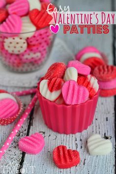 valentine's day cupcakes in pink and white frosting with candy hearts