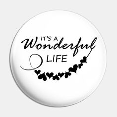 it's a wonderful life button with hearts and leaves on the front, in black ink