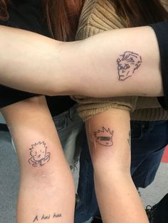 two people with matching tattoos on their arms