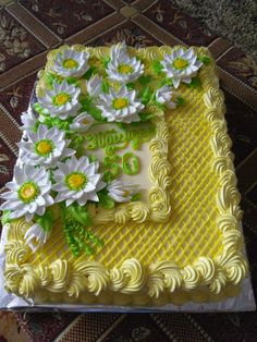 a cake decorated with white and yellow flowers