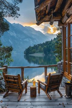 two wooden chairs sitting on top of a wooden deck next to a body of water