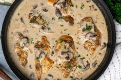 a pan filled with chicken and mushrooms covered in gravy next to broccoli