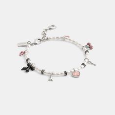 A dazzling array of Coach motifs combine on this playful beaded bracelet. Brightened with pops of color and sparkling crystals it’s finished with an adjustable clasp closure. | Coach Mini Bow Charms Pearl Bracelet - Women's - Silver/pearl Multi Adjustable Beaded Bracelets With Sparkling Stones, Adjustable Silver Coach Bracelet, Silver Coach Bracelet Gift, Silver Coach Bracelets As A Gift, Trendy Adjustable Bracelet With Removable Charms, Silver Coach Bracelet As Gift, Elegant Adjustable Bracelet With Removable Charms, Silver Coach Bracelet For Gift, Elegant Bracelet With Adjustable Removable Charms