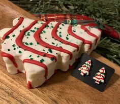 a piece of cake sitting on top of a wooden table next to a christmas tree