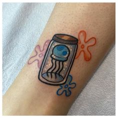 a tattoo with an image of a jelly jar on it's left arm and blue eyes