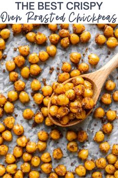 the best crispy oven roasted chickpeas on a baking sheet with a wooden spoon